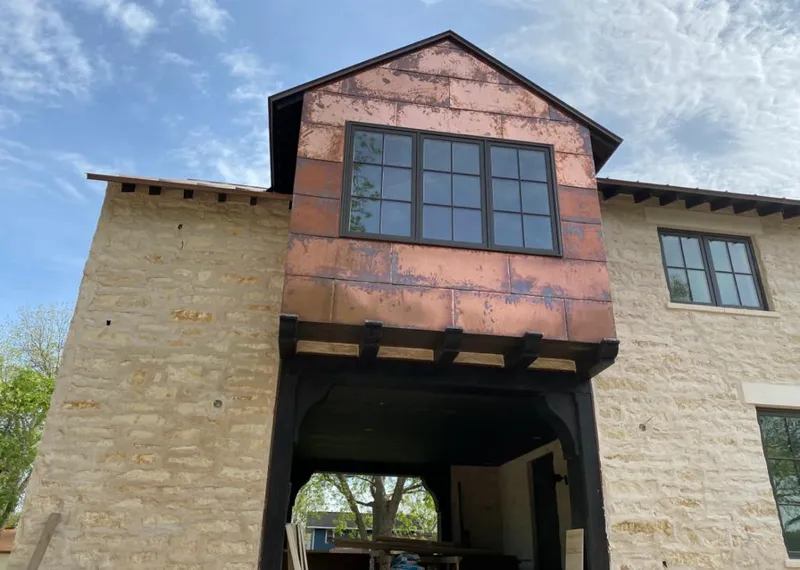 Copper metal panel facade on a stone building for Metal Roof Coating in Winnemucca